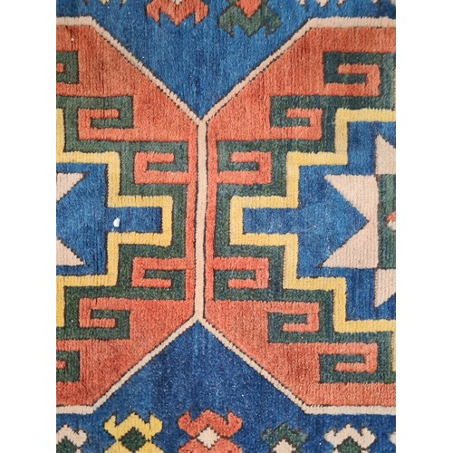 945 - Star lot : A beautiful hand made Persian rug featuring geometric patterns in tone of blue, orange, y... 