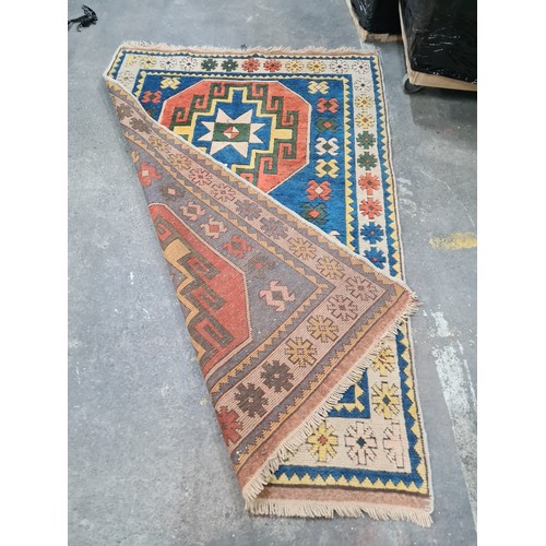 945 - Star lot : A beautiful hand made Persian rug featuring geometric patterns in tone of blue, orange, y... 