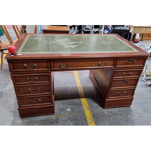 1094 - Star Lot : A handsome vintage double sided partners  desk featuring a moss green leather top with gi... 