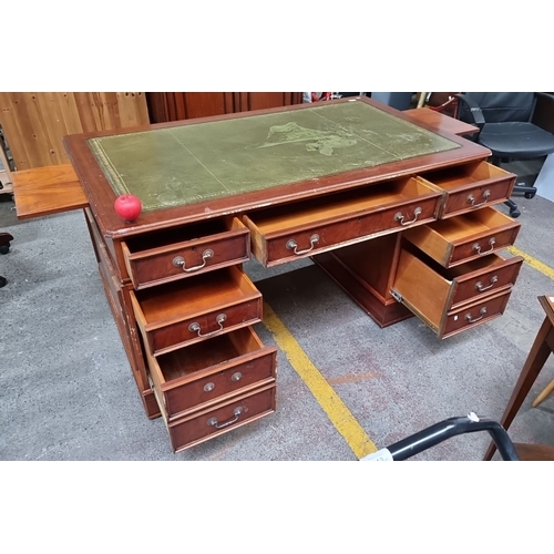 1094 - Star Lot : A handsome vintage double sided partners  desk featuring a moss green leather top with gi... 