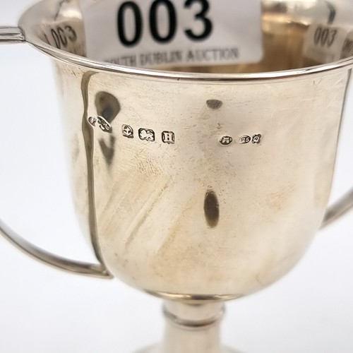 3 - A sterling silver challenge cup set with C handles hallmarked Birmingham. Dimensions: 6.5 cms diamet... 