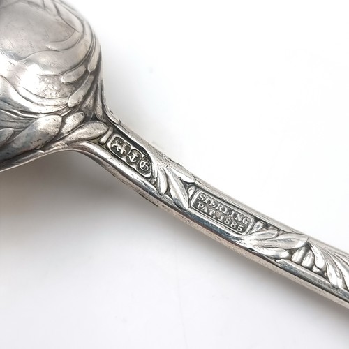 15 - A sterling silver spoon with highly decorated fiddle pattern handle. Length - 18 cms. Weight - 55.07... 