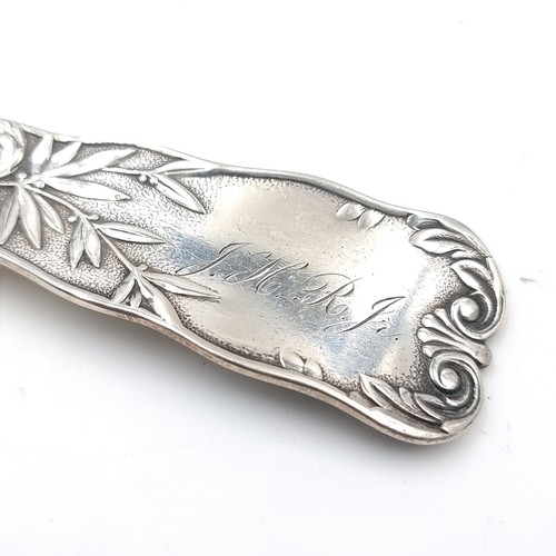 15 - A sterling silver spoon with highly decorated fiddle pattern handle. Length - 18 cms. Weight - 55.07... 