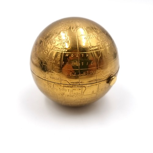 52 - An unusual vintage powder compact in the form of a world globe. Comes with original pouch.