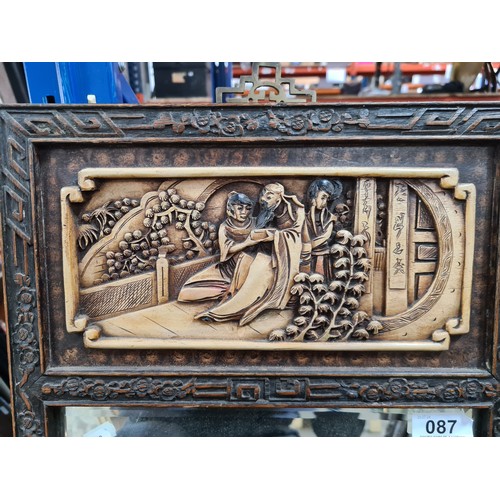 87 - Star Lot : An antique wooden relief carved beveled mirror featuring Chinese narratives.
MM: 34 x 33 ... 