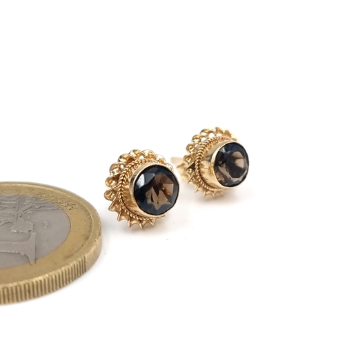 10 - A pair of nine carat gold smoky quartz stud earrings. Weight - 1.5 grams.