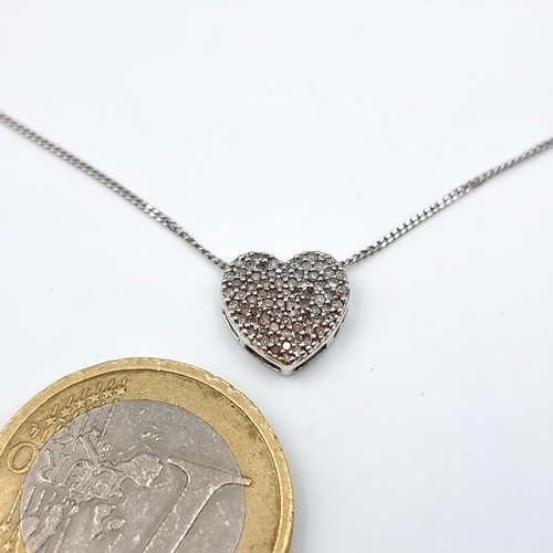 14 - A very pretty heart shaped diamond pendant necklace set in nine carat white gold. Length of chain - ... 