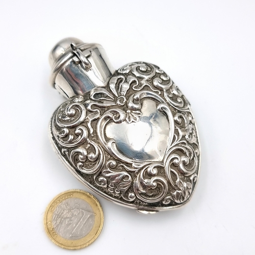 19 - A very nice example of a Sterling silver hinged perfume pendant with a repoussé design. Dimensions: ... 