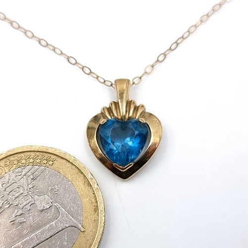 25 - A nine carat gold blue topaz heart shaped pendant necklace with chain. Length of chain - 46 cms. Tot... 