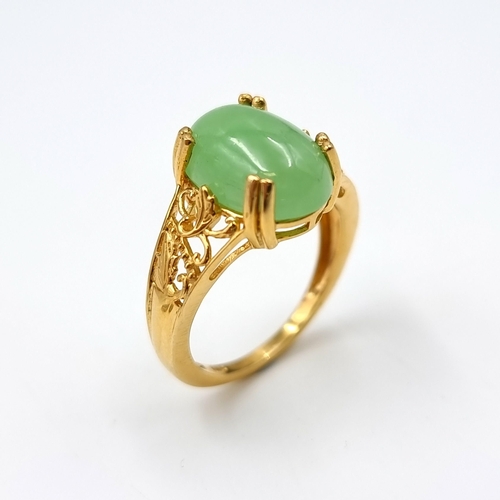 30 - An attractive cabochon jade stone ring set in silver gilt. Ring size - R. Weight - 4.52 grams.