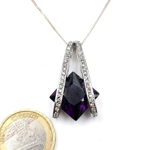 41 - A sterling silver amethyst cushion cut pendant necklace with gem set surround. Length of chain - 44 ... 