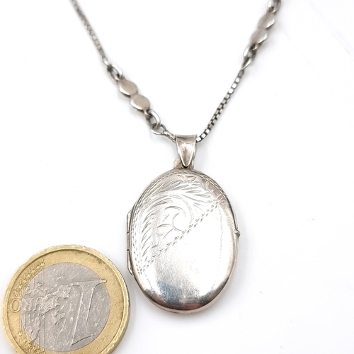 44 - A nice example of a sterling silver locket with foliette design set with a fancy silver chain. Lengt... 