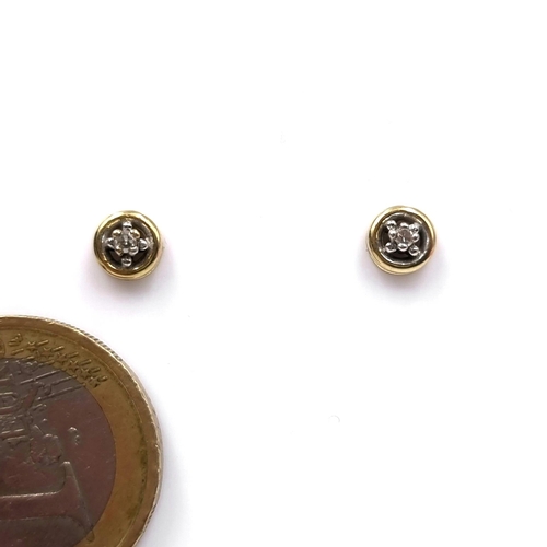 9 - A pair of nine carat gold diamond set stud earrings. Weight - 1.24 grams.