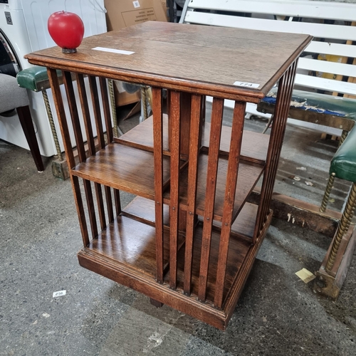 774 - A stunning Edwardian two tier revolving book case. Slight split to top.