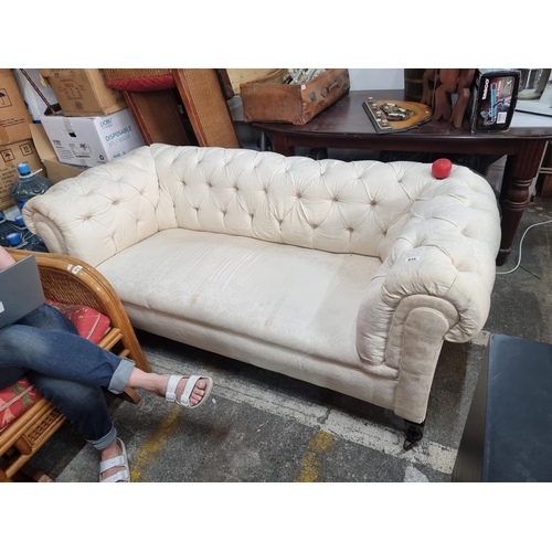 816 - Star lot : An elegant Victorian roll arm Chesterfield with deep buttoned back and scroll arms. Uphol... 