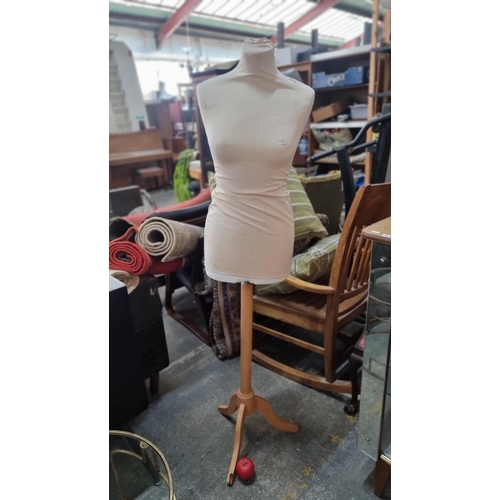 819 - A dress maker style mannequin on a wooden tripod stand