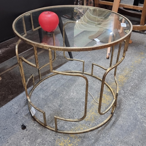 821 - Star Lot : A brand new designer neatly sized glass topped coffee table on a gold toned metal base. F... 