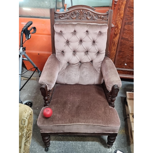 849 - A Victorian  deep buttoned armchair sat on castor wheels featuring lovely carved detailing, turned w... 