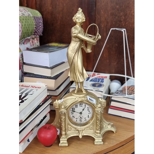 861 - A beautiful vintage cast gilt metal clock adorned with a poised female to top and finished in a gilt... 