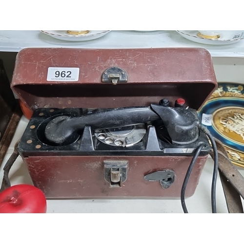 962 - A vintage mid-20th century field telephone in a rugged brown leather case with rotary dial and integ... 