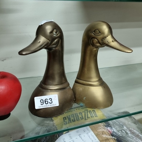 963 - A pair of brass duck head bookends with a rich patina.