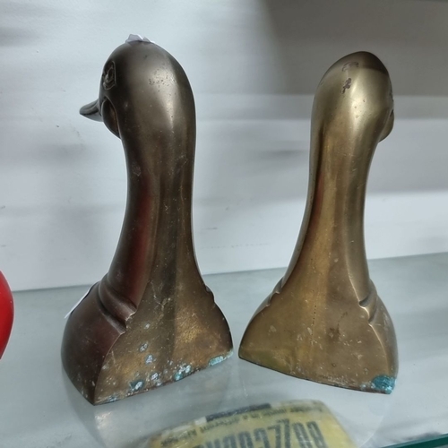 963 - A pair of brass duck head bookends with a rich patina.