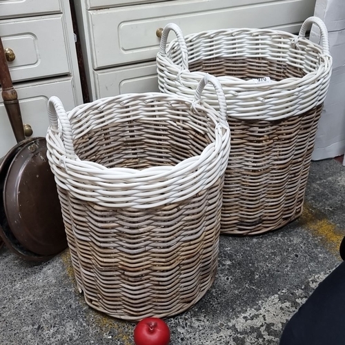 970 - A pair of woven wicker baskets with handles, featuring a two-tone design in natural and white.