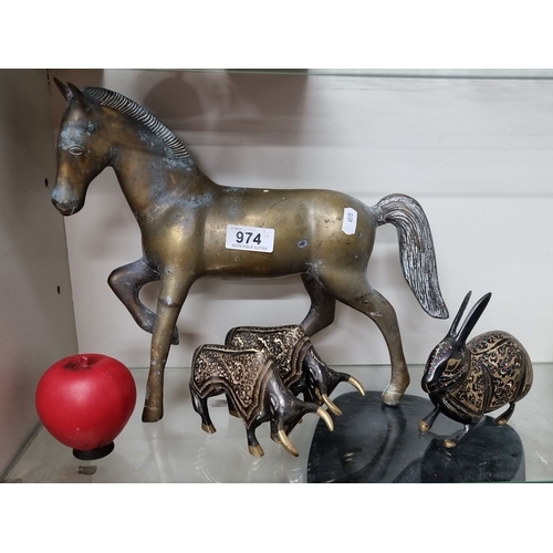 974 - One brass horse, two ornate bulls, and one patterned rabbit decorative metal figurines.