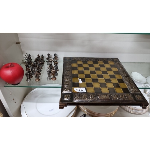 976 - A complete 32 piece Bronze Roman-themed chess set with ornate bronze-board. Intricately detailed pie... 