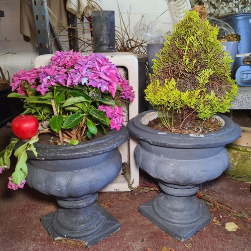 770 - A pair of reconstituted stone urn shaped planters. Slight damage to base of each. From the lovely ho... 