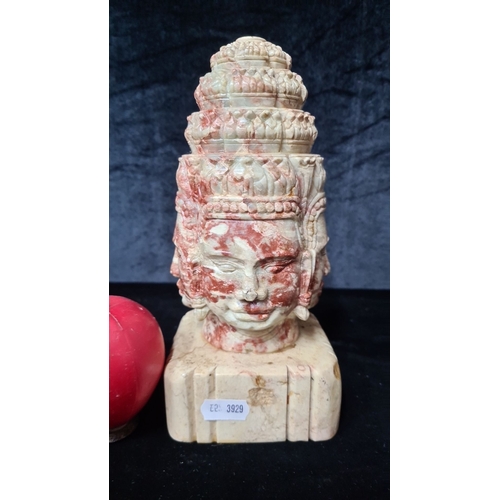 934 - An intricately carved marble bust depicting multiple faces in a traditional Asian style, mounted on ... 