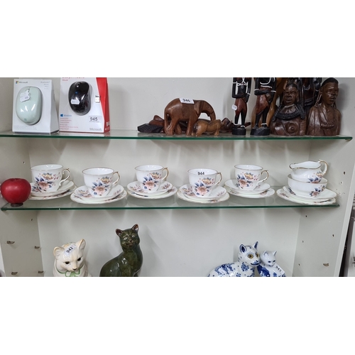 944 - A set of Arklow Fine Irish Bone China includes teacups, saucers, and a creamer. It features a delica... 