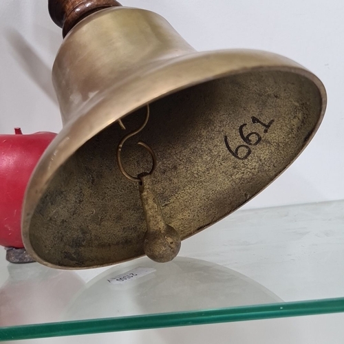 948 - An antique brass hand bell with turned wood handle, likely  early 20th century. The inside is marked... 