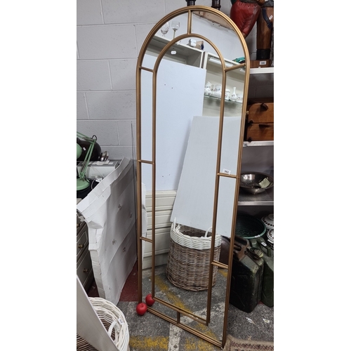 982 - Star LoT : A brand new very large full length arched mirror with a gold-tone metal frame, featuring ... 