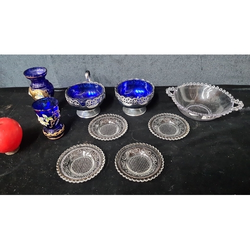 984 - A collection of nine pieces, featuring cobalt blue glass decor with floral enamel details and clear ... 