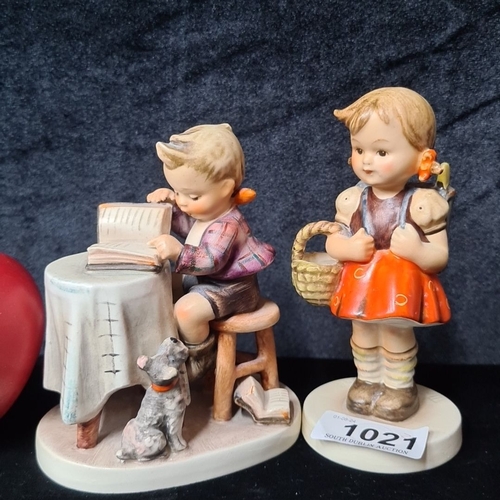 1021 - Two  Hummel figurines by Goebel. These are hand-painted porcelain featuring children carrying a bask... 