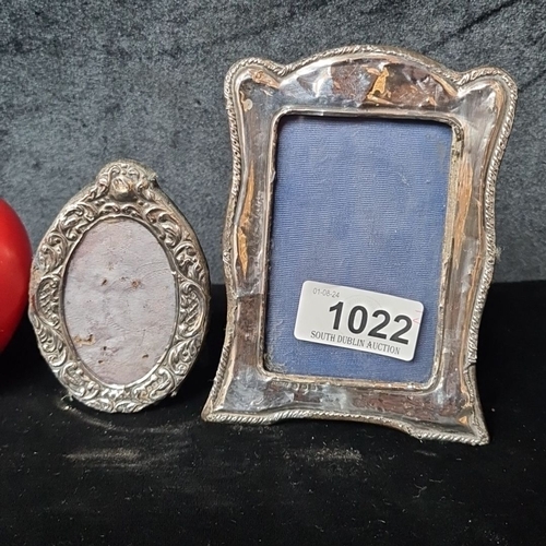 1022 - Two vintage sterling silver photo frames with ornate detailing. Includes one oval and one rectangula... 