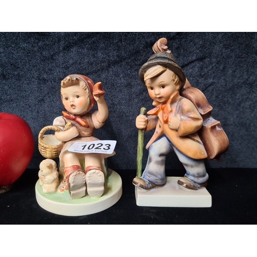 1023 - Two Hummel figurines from West Germany. Each porcelain figure is hand-painted, depicting a child in ... 