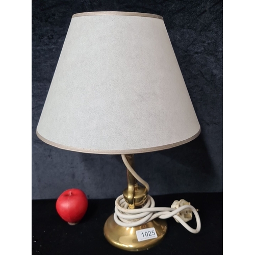 1025 - A brass Gimble ships table lamp with a white fabric beige lampshade. The lamp features brass body an... 