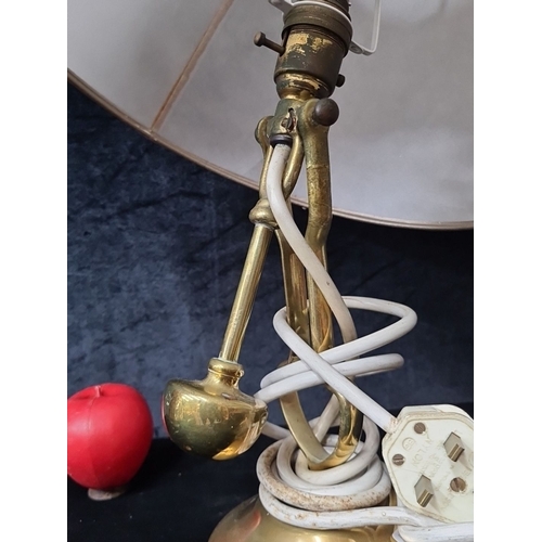 1025 - A brass Gimble ships table lamp with a white fabric beige lampshade. The lamp features brass body an... 