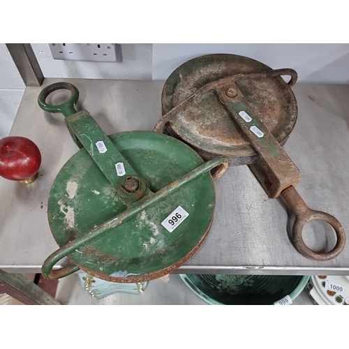 996 - A pair of vintage industrial pulley wheels with green-painted metal frames. Circular design with stu... 