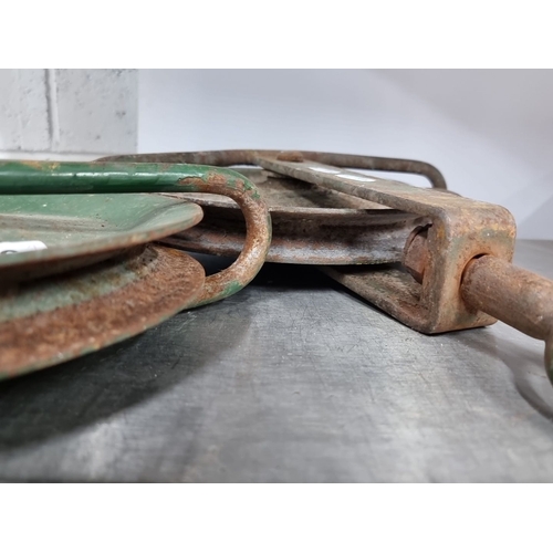 996 - A pair of vintage industrial pulley wheels with green-painted metal frames. Circular design with stu... 