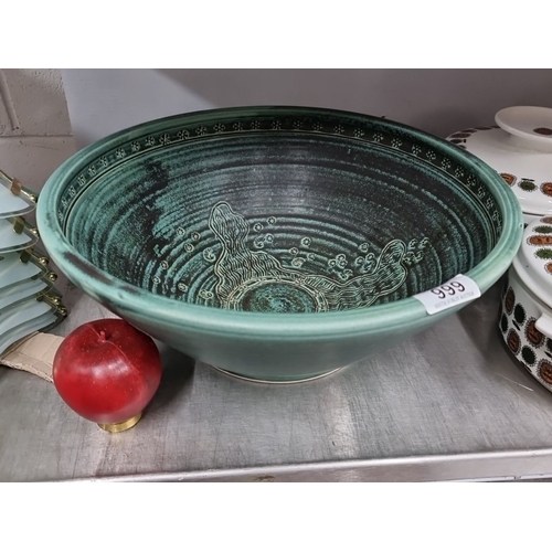 999 - A beautiful green stoneware bowl with intricate interior pattern, stamped 