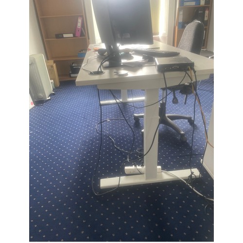 1049 - A White Standing electric desk that you can sit or stand at. In nice clean condition same office.