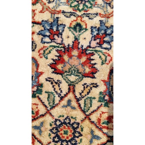 842 - Star Lot : A wonderful large Persian style wool rug in rich tones of dark blue, cream, red and dark ... 