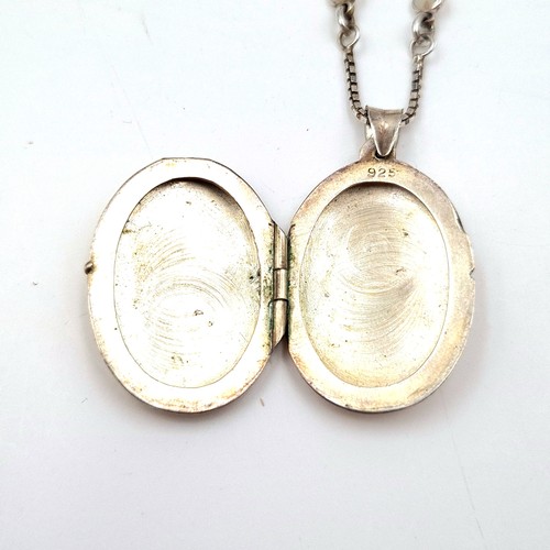 44 - A nice example of a sterling silver locket with foliette design set with a fancy silver chain. Lengt... 