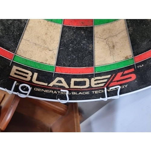 991 - A Winmau Blade 5 dartboard, professional-grade sisal board with embedded numbering system.