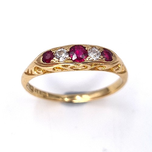 13 - Star Lot : An attractive five stone diamond and ruby set ring mounted in 18 carat gold. Size - N. We... 