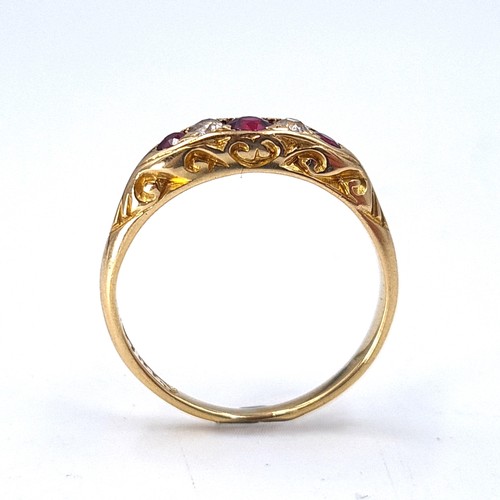 13 - Star Lot : An attractive five stone diamond and ruby set ring mounted in 18 carat gold. Size - N. We... 