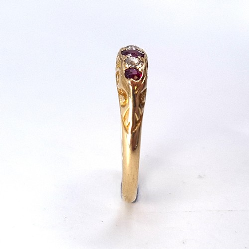 13 - Star Lot : An attractive five stone diamond and ruby set ring mounted in 18 carat gold. Size - N. We... 